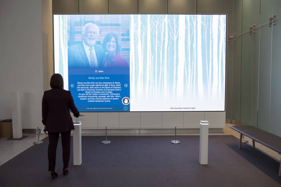 woman in front of interactive wall