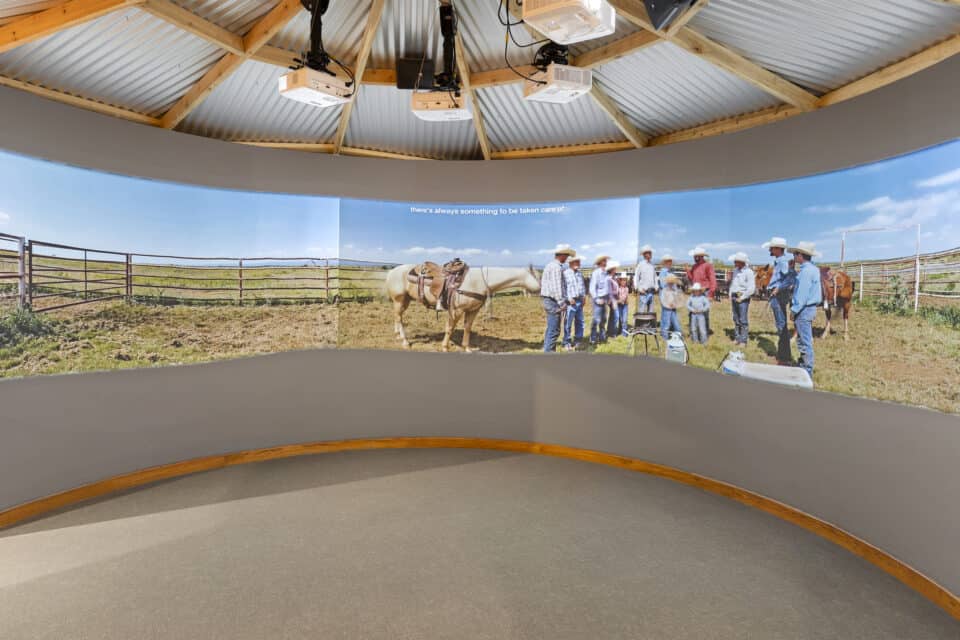 video of ranchers projected in round space